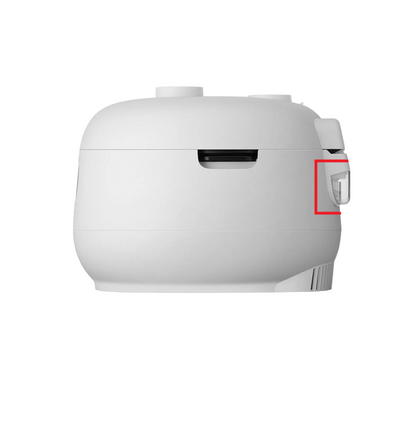 A white electric rice cooker shown from the side against a white background, with a red rectangular highlight around a small side control or switch.