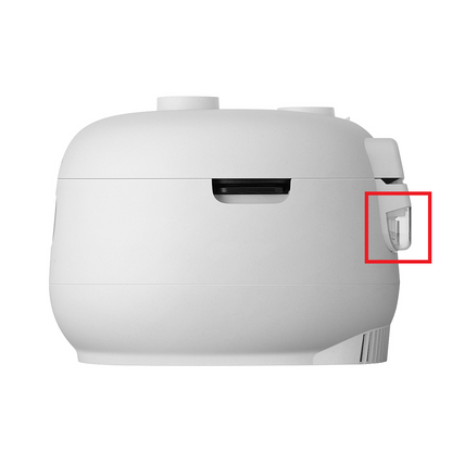 A white rice cooker shown from the side on a plain white background, with a red square highlighting a small side control or latch.